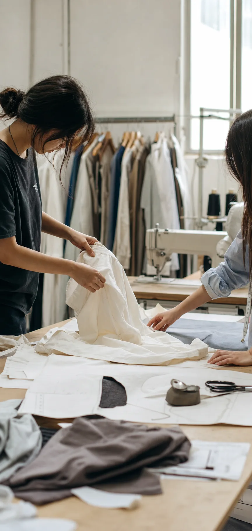Documentary-style Guangzhou apparel sample room with patterns, fabrics, and sample garments