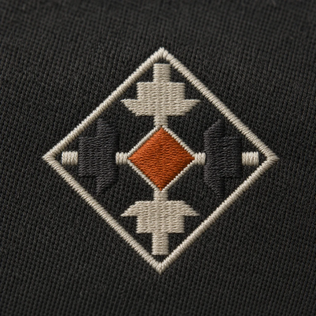 Close-up of embroidered stitches on a dark garment