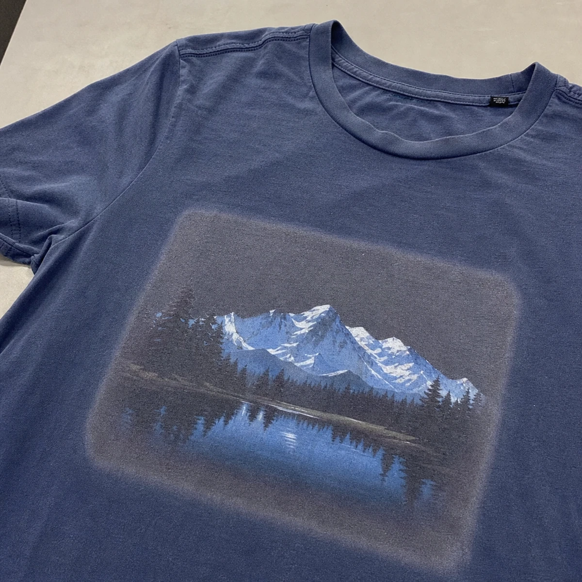 Illustrative garment showing a visible pretreatment mark around the print