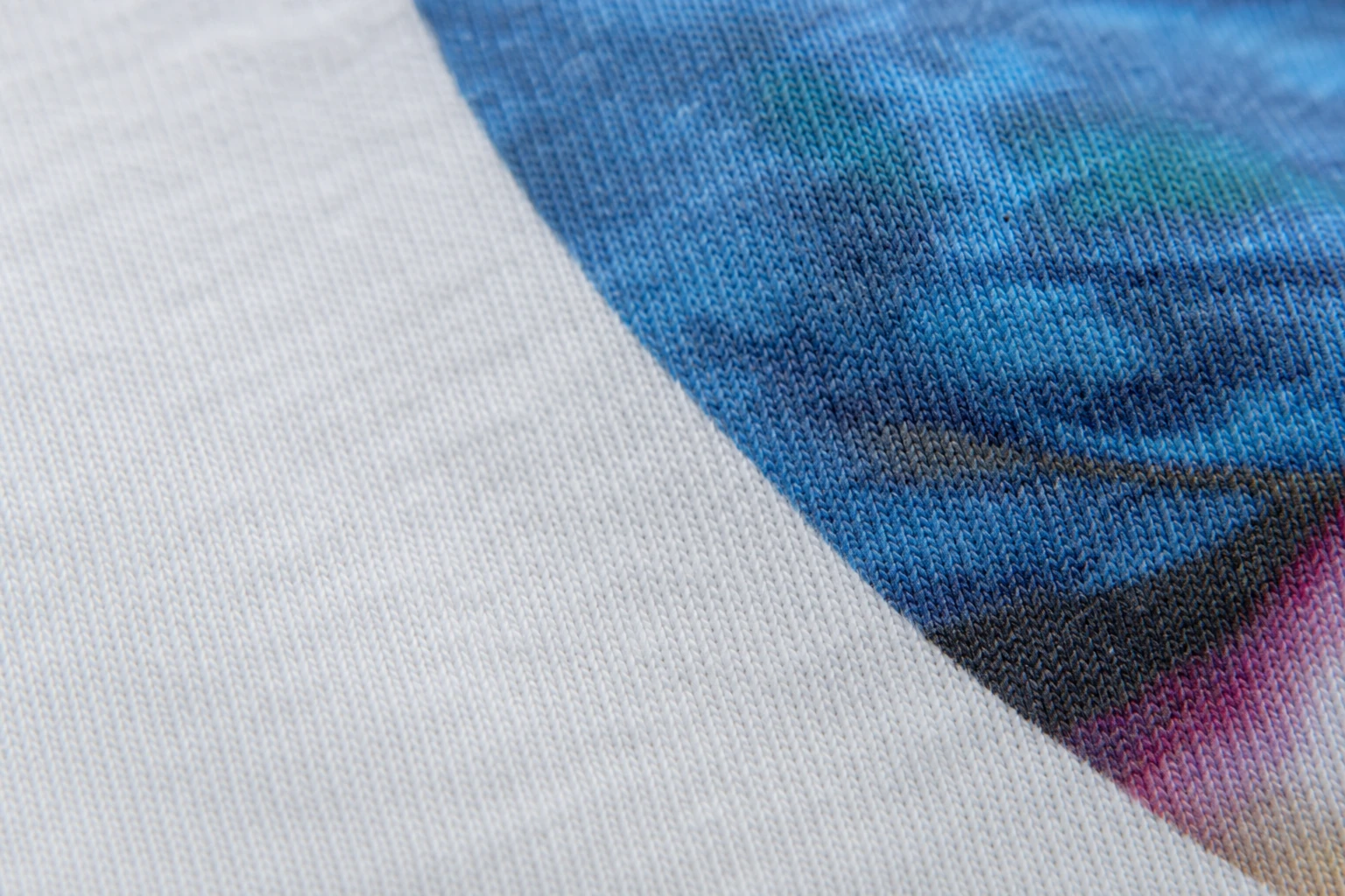 CMYK digital print detail on a light cotton garment
