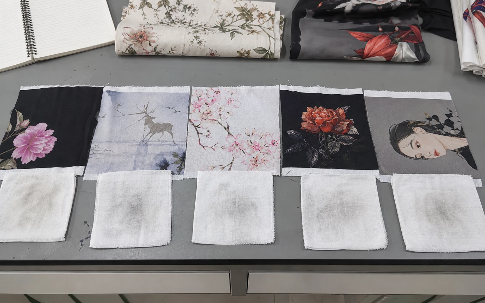 Washed digital print samples and dry wet rubbing checks on a QC table