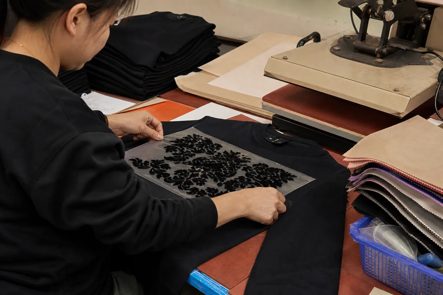 Pre-flocked transfer positioned on a garment before heat application