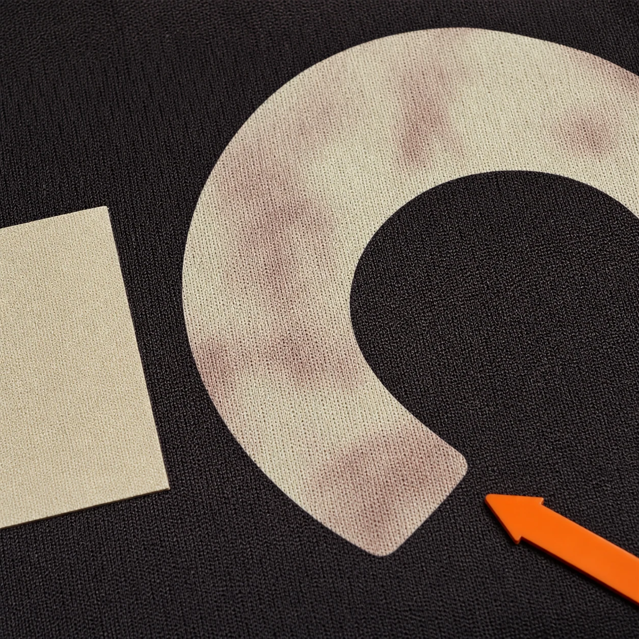 Dark polyester dye visible through a light transfer sample