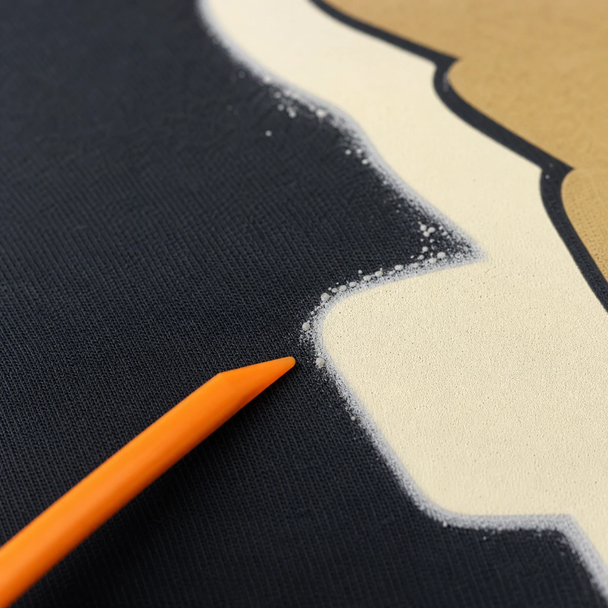 Uneven powder edge and small lumps around a DTF graphic