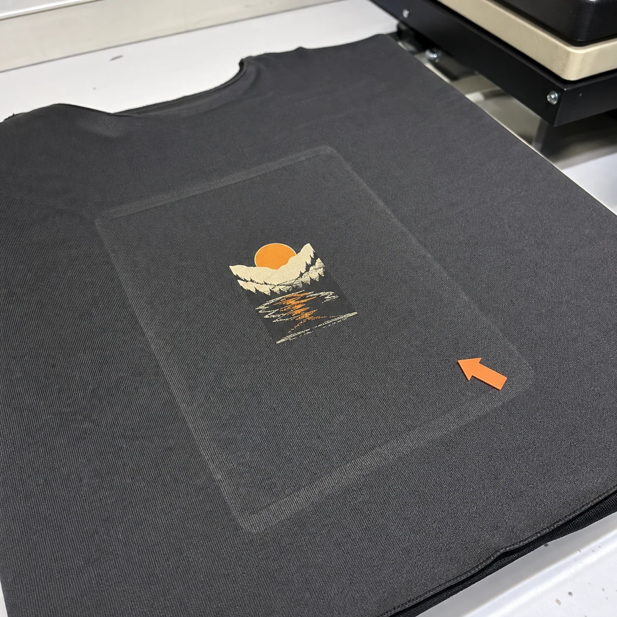 Visible gloss and platen outline around a pressed garment area