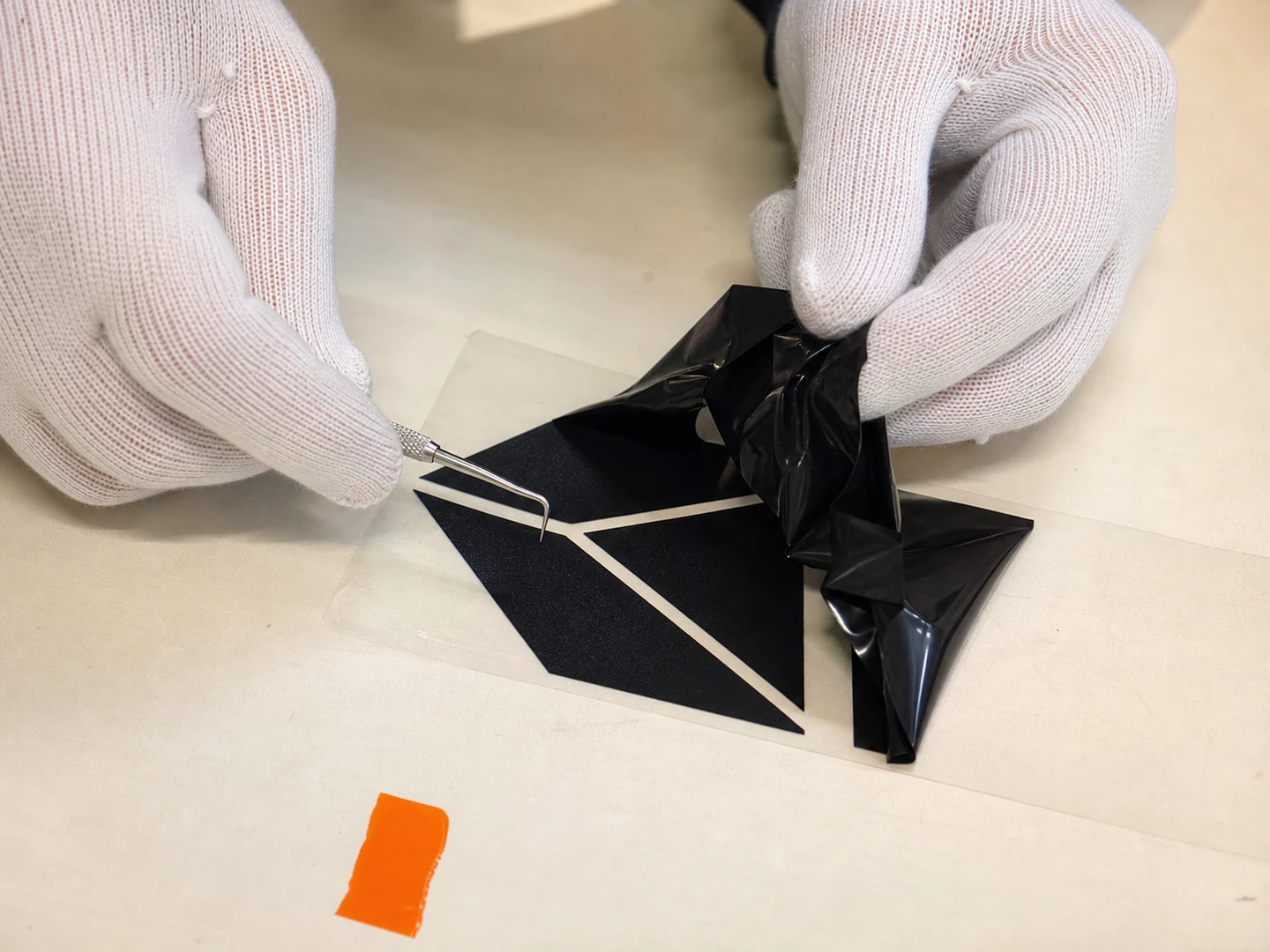 Close view of excess film being weeded from a cut HTV design
