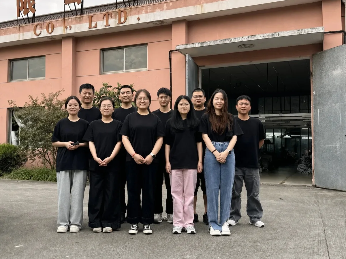 Canton Fashion team outside a partner garment factory