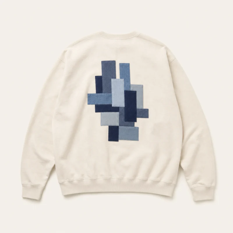Ivory sweatshirt with original blue geometric applique.